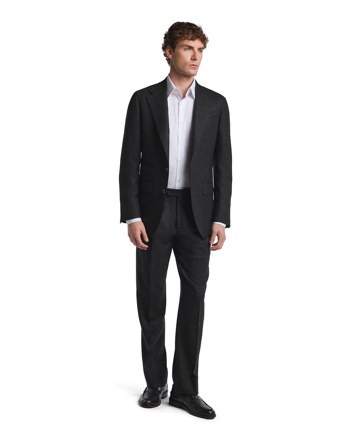 Men's tailored black wool suit with a crisp white shirt, perfect for formal occasions and business events.