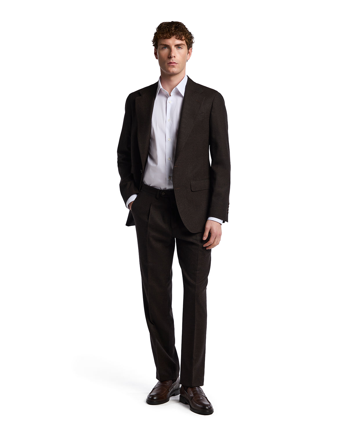 Men's dark brown tailored suit in wool blend, paired with a crisp white dress shirt and stylish brown shoes.