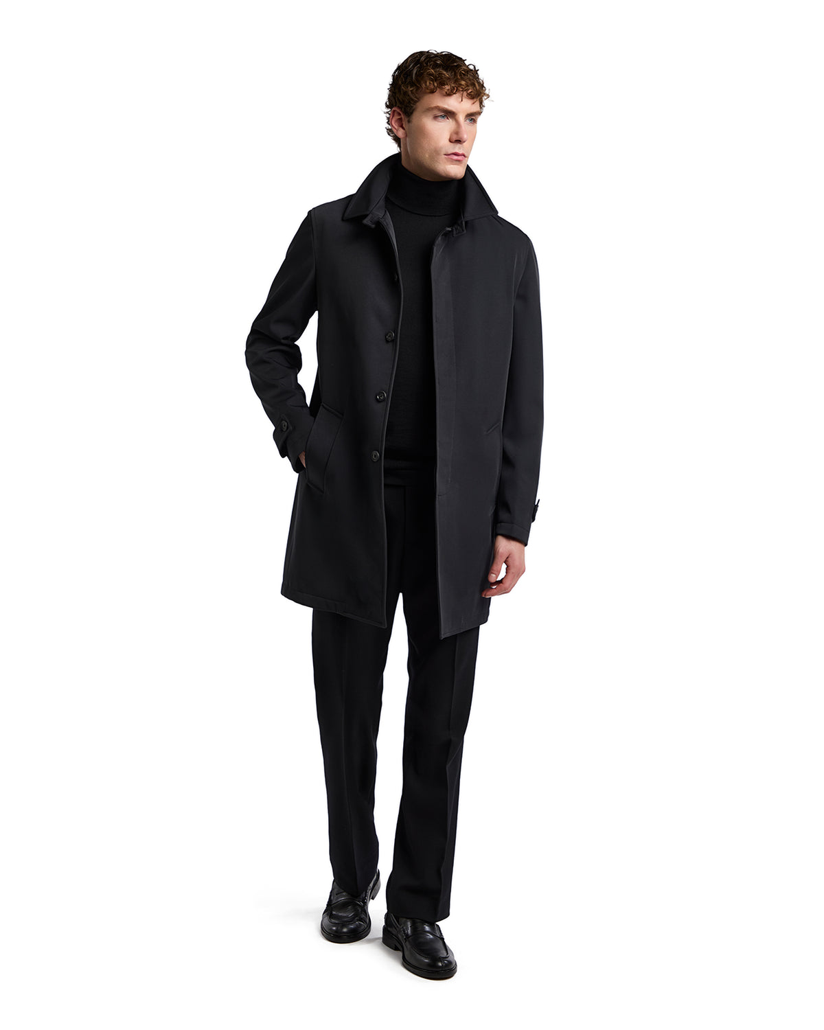 Men's black overcoat in tailored style, made from durable fabric, paired with a sleek turtleneck and trousers.