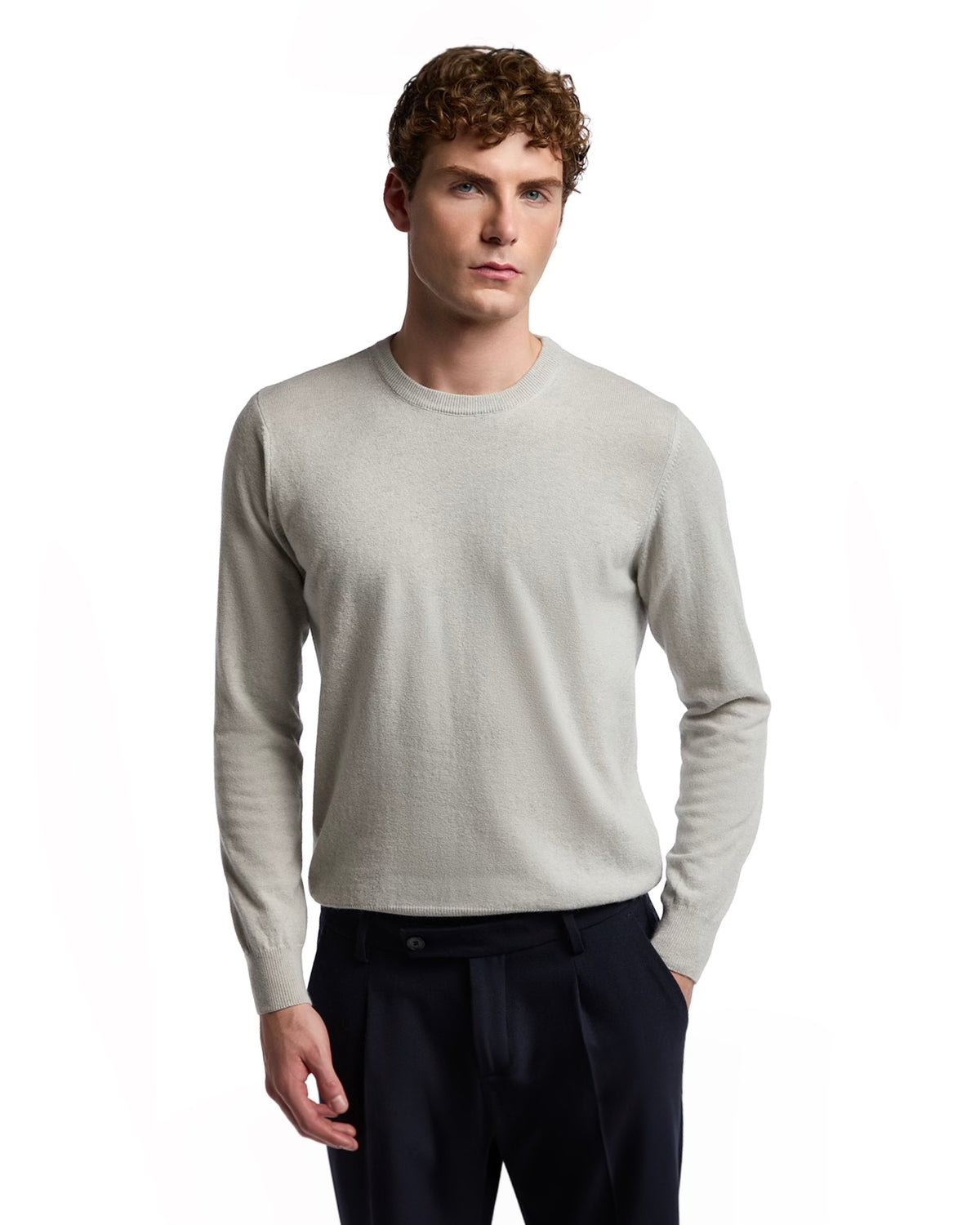 Men's light gray cashmere sweater, crew neck, classic fit, paired with navy dress trousers.